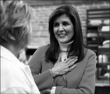  ?? CODY SCANLAN / THE DES MOINES REGISTER VIA ASSOCIATED PRESS ?? Republican presidenti­al candidate Nikki Haley speaks with a supporter during a campaign stop Monday in Pella, Iowa, ahead of the state’s caucuses.