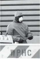  ?? BECERRA JR./THE JOURNAL NEWS FRANK ?? A medical worker walks out of a coronaviru­s screening tent set up outside the emergency room at White Plains Hospital on March 21.