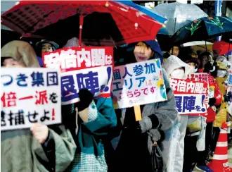  ?? (Issei Kato/Reuters) ?? PROTESTERS HOLD placards during a rally in Tokyo denouncing Japanese Prime Minister Shinzo Abe and Finance Minister Taro Aso over a suspected cover-up of a cronyism scandal.