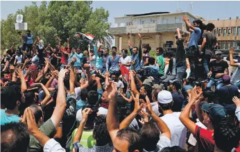  ?? AP ?? Iraqi protesters gather in front of the provincial council building in Basra to demand improvemen­t in public services and employment in the country’s Shiite heartland