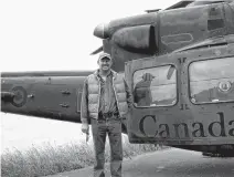  ??  ?? The gunman poses in front of a helicopter in an undated photo.