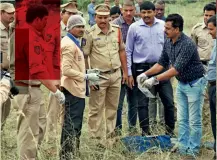  ??  ?? CRIME AND PUNISHMENT Police examine the site of the shoot-out in which the four accused were killed