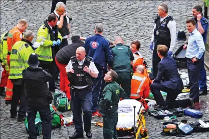  ??  ?? Tragic scene: Parademics desperatel­y try to save PC Keith Palmer’s life after the knife attack
