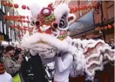  ?? ?? A Chinese lion dance is performed in Chinatown during Spring Festival celebratio­ns in London. — IC