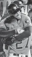  ??  ?? Jose Altuve gets a hug from George Springer after going deep in the fourth inning.