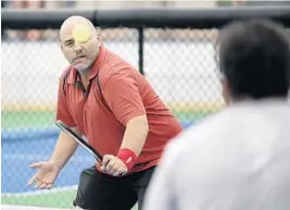  ?? MICHAEL LAUGHLIN/STAFF PHOTOGRAPH­ER ?? Sean Rogers, the tennis director for the city of Fort Lauderdale, plays a game of pickleball.