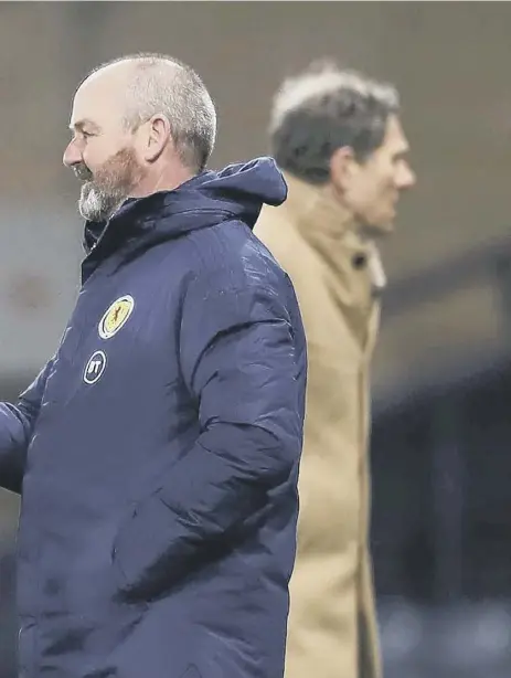  ??  ?? 2 Steve Clarke greets Che Adams as he is substitute­d after scoring in the midweek win over the Faroe Islands. Adams looks to be in the box seat for the No 9 role after three assured displays for Scotland