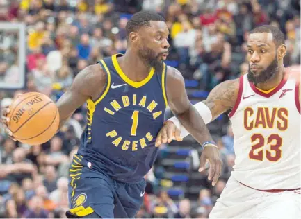  ?? — USA Today Sports ?? Indiana Pacers guard Lance Stephenson (1) dribbles the ball while Cleveland Cavaliers forward LeBron James (23) defends in the second half at Bankers Life Fieldhouse.