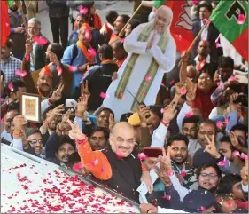  ?? IANS ?? Bharatiya Janata Party chief Amit Shah being welcomed by party workers at BJP Headquarte­rs in New Delhi, on Monday.