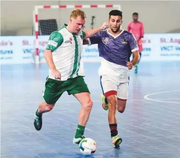  ?? Courtesy organiser ?? Paul Scholes being challenged by a rival player Premier Futsal onTuesday night in Dubai.