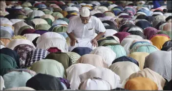  ?? ASSOCIATED PRESS ?? Muslims offer prayers on Wednesday at National Mosque for the Eid al-Fitr, marking the end the holy fasting month of Ramadan, in Kuala Lumpur, Malaysia.
