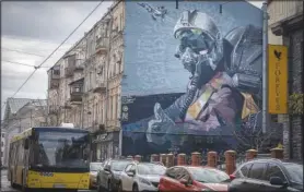  ?? ?? A mural depicts a Ukrainian pilot showing a thumbs-up sign on an apartment building wall Jan. 19 in Kyiv.