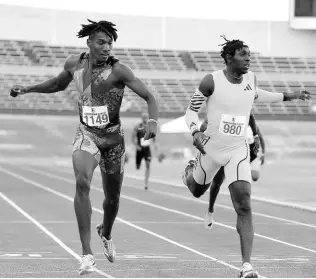  ?? ?? Swept Track Club’s Roshawn Clarke (left), edges Antonio Watson to the line in the men’s 400 metres at the Camperdown Classic inside the National Stadium yesterday.