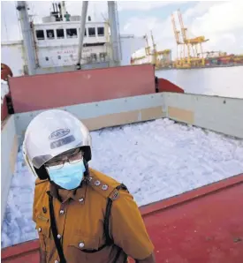  ?? AP ?? A Sri Lankan port worker stands on a ship that carried emergency supplies granted as humanitari­an aid by the Indian government to the Sri Lankan people at a port in Colombo.