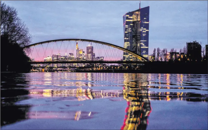  ?? Michael Probst The Associated Press file ?? The European Central Bank is reflected in the river Main in Frankfurt, Germany, last month. Inflation fell more than expected in March to 2.4 percent.