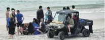  ??  ?? Help on hand . . . Offduty surf lifesavers, St John paramedics and water rescue squad members comfort four people after they were rescued from a rip at St Kilda Beach.