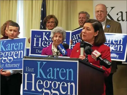  ?? PAUL POST — PPOST@DIGITALFIR­STMEDIA.COM ?? Saratoga County District Attorney Karen Heggen, right, announces her candidacy Thursday for re-election to a new four-year term. She was joined by many family members including her mother, Marilyn, center, and husband, the Rev. Peter Klotz, top right.