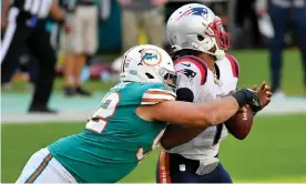  ?? Photograph: Jasen Vinlove/USA Today Sports ?? Miami Dolphins defensive end Zach Sieler (92) sacks New England Patriots quarterbac­k Cam Newton (1) during the second half of Sunday’s game at Hard Rock Stadium.