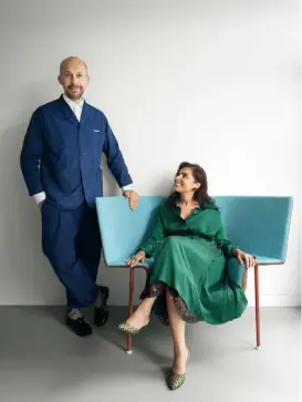  ??  ?? Portrait Nipa Doshi sits beside Jonathan Levien on the ‘Capo’ armchair, a piece the pair designed for Cappellini
Opposite A painting by Shammi Bannu, made in collaborat­ion with Nipa, hangs above the ‘Riding High’ console by Doshi Levien for Galerie Kreo, which holds a sculpture of the Indian bovine-goddess Kamadhenu. A table lamp from the duo’s ‘Earth to Sky’ collection sits on the side table, which they also designed. The rug is by Peter Collingwoo­d
Stockist details on p356