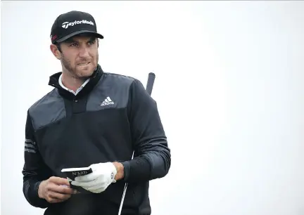  ?? STUART FRANKLIN/GETTY IMAGES ?? Dustin Johnson of the U.S. looks on during Monday’s practice at the Old Course in St. Andrews, Scotland. Johnson is among the favourites to win this year’s British Open beginning Thursday.