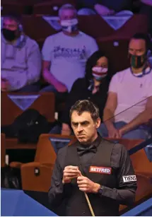  ??  ?? Cue up: Masked fans watch Ronnie O’Sullivan