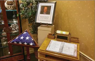  ?? STAFF PHOTO ?? A registry in honor of former President George H.W. Bush was available for visitors of Kettering’s Routsong Funeral Home to sign on Monday. It will be sent to the Bush family.