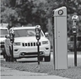  ?? [ERIC ALBRECHT/DISPATCH] ?? A “pay-by-plate” parking kiosk sits among more convention­al parking meters on Park Street Monday. The kiosks have also been installed on Nationwide Boulevard.