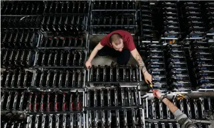  ?? Photograph: Alessandro Bianchi/Reuters ?? Employees at work at a bitcoin factory in Italy. The failure of Celsius earlier in June began the second wave of the crypto crash.