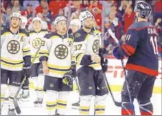  ?? AP ?? Boston players line up to shake hands with Carolina players following Hurricanes’ win in Game 7of their first-round series on Saturday.