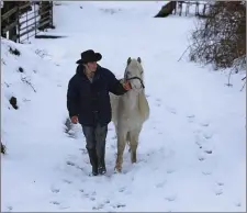  ?? Valerie O’Sullivan Photo by ?? Johnny ‘The Rock’ O’Brien from Glenflesk checking on his beloved Connemara Pony as harsh weather disrupted farming life.