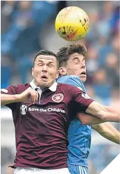  ??  ?? ■
Hearts’ Don Cowie challenges Aberdeen’s Ryan Christie.