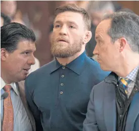  ??  ?? MMA fighter Conor McGregor, centre, during his arraignmen­t in Brooklyn.