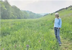  ??  ?? Donna Cox is part of a growing movement to restore Britain’s meadows, saying she feels ‘pure joy’ at the proliferat­ion of flowers and wildlife