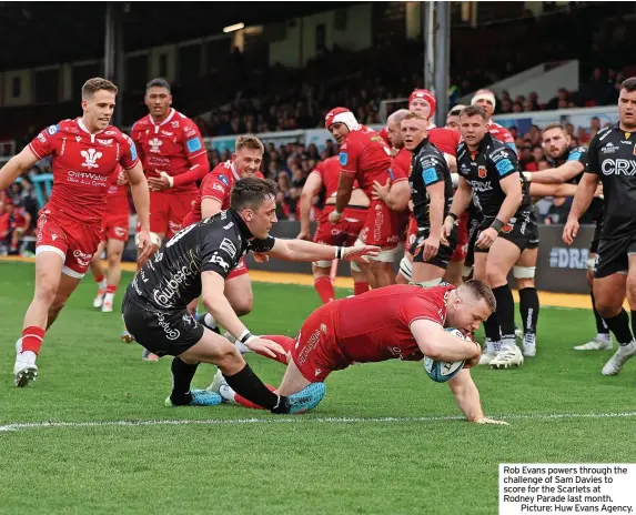  ?? ?? Rob Evans powers through the challenge of Sam Davies to score for the Scarlets at Rodney Parade last month.
Picture: Huw Evans Agency.