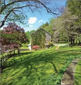  ?? SUBMITTED PHOTOS ?? The sunny and airy kitchen has pickled cherry cabinets, large center island and a working fireplace.