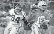  ?? LM Otero / AP ?? Ohio State quarterbac­k J.T. Barrett (16) is chased by Southern California defensive tackle Rasheem Green (94) during the first half of the Cotton Bowl.