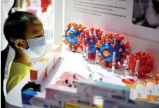  ?? — AFP photo ?? A boy looks at Sinovac Biotech LTD’s vaccines for the Covid-19 coronaviru­s on display at the China Internatio­nal Fair for Trade in Services (CIFTIS) in Beijing.