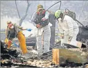  ?? AFP ?? Rescue workers search an area for human remains in a home destroyed by a wildfire in Paradise, California.