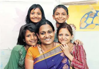  ??  ?? Kriti, pictured with street children at Badhtey Kadam, a rehabilita­tion centre she also runs, received an award from TV channel Colors in 2008 for her work preventing child marriages