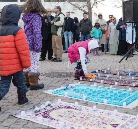  ?? BRANDON HARDER ?? Fifty candles, one for each victim of the terror attacks in New Zealand, were placed outside city hall during a vigil Thursday.