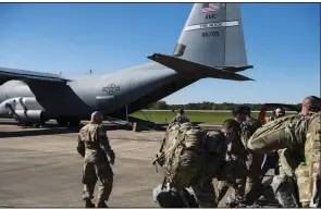  ?? AP/U.S. Air Force/AIRMAN 1st CLASS ZOE M. WOCKENFUSS ?? Members of the Army 89th Military Police Brigade get ready to board a C-130 from Little Rock Air Force Base on Monday at Fort Knox, Ky., for deployment to south Texas.