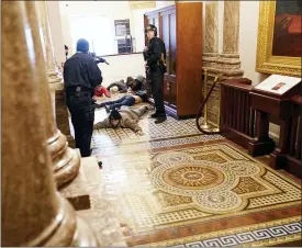  ?? ANDREW HARNIK — THE ASSOCIATED PRESS ?? U.S. Capitol Police hold protesters at gun-point near the House Chamber inside the U.S. Capitol on Wednesday, in Washington.