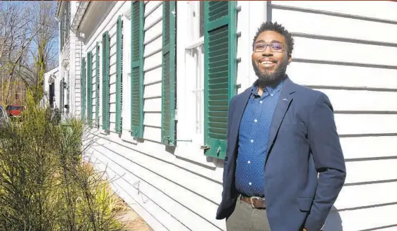  ?? BARBARA HADDOCK TAYLOR PHOTOS ?? Christophe­r Wharton stands in front of his home on Pickwick Road in the historic Baltimore neighborho­od of Dickeyvill­e, which was founded in 1772.