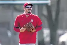  ?? Jeff Roberson, The Associated Press ?? St. Louis Cardinals infielder Nolan Arenado smiles as he jogs out to his position during spring training baseball practice Monday in Jupiter, Fla.