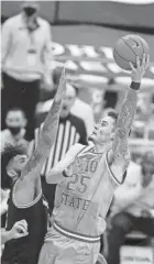  ?? JOSEPH MAIORANA/USA TODAY SPORTS ?? Ohio State forward Kyle Young shoots against Michigan forward Isaiah Livers on Sunday.