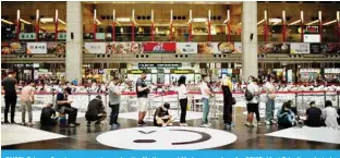  ?? ?? TAIPEI, Taiwan: People queue up to receive the Medigen and Moderna vaccines for COVID-19 at Taipei’s main train station. —AFP