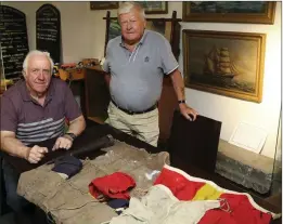  ??  ?? John Mahon presents artefacts to Danny O’Neill, Chairman of Arklow Maritime Museum.