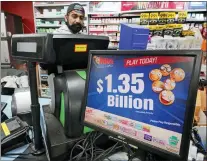  ?? GENE J. PUSKAR — THE ASSOCIATED PRESS FILE ?? A Mega Million sign displays the estimated jackpot of $1.35Billion at the Cranberry Super Mini Mart in Cranberry, Pa., on Jan. 12. The winner of a $1.35 billion Mega Millions jackpot has come forward to collect the prize. The Maine State Lottery announced Wednesday that the winner chose to remain anonymous and collect the cash option through a limited liability company instead of receiving the full amount in payments over time.