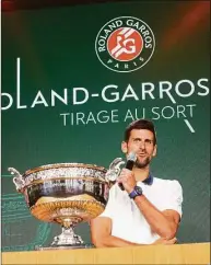  ?? Michel Euler / Associated Press ?? Novak Djokovic speaks next to the cup during the draw of the French Open at the Roland Garros stadium in Paris on Thursday.