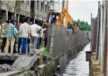  ??  ?? Officials demolishin­g one of the unauthoris­ed buildings at Marutinaga­r in Chintal on Tuesday.